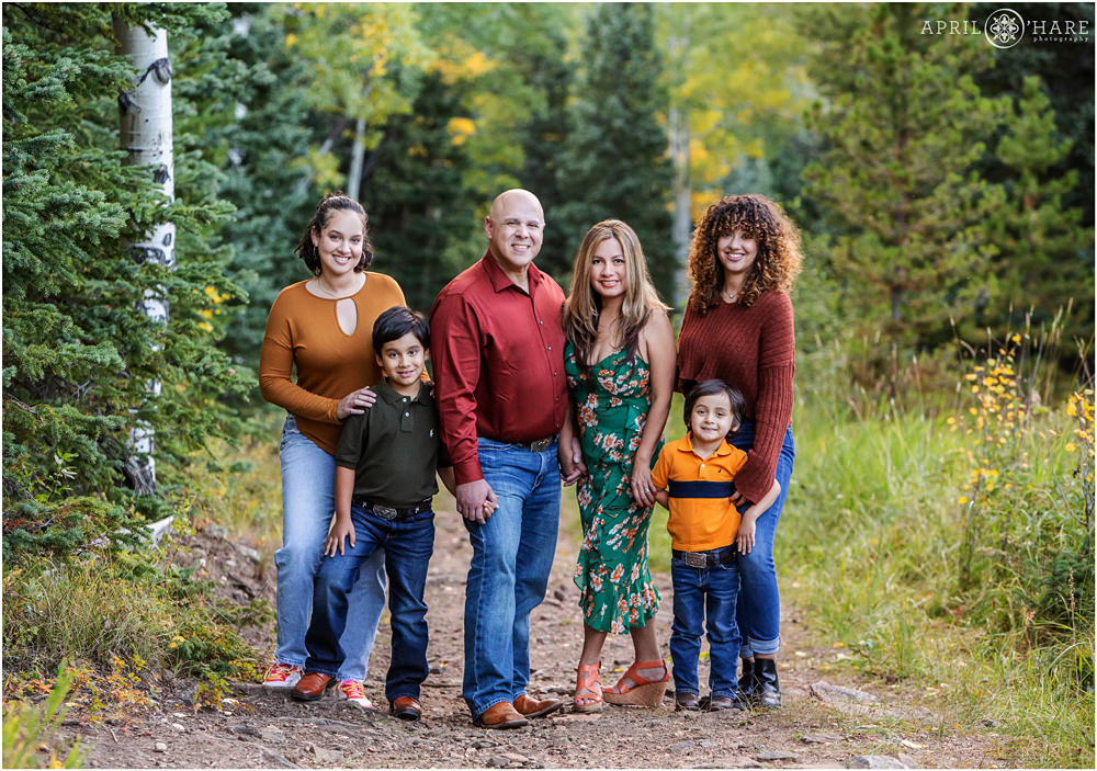 Colorful Colorado Family Photo Jewel Toned Clothing on a Forest Path in Evergreen