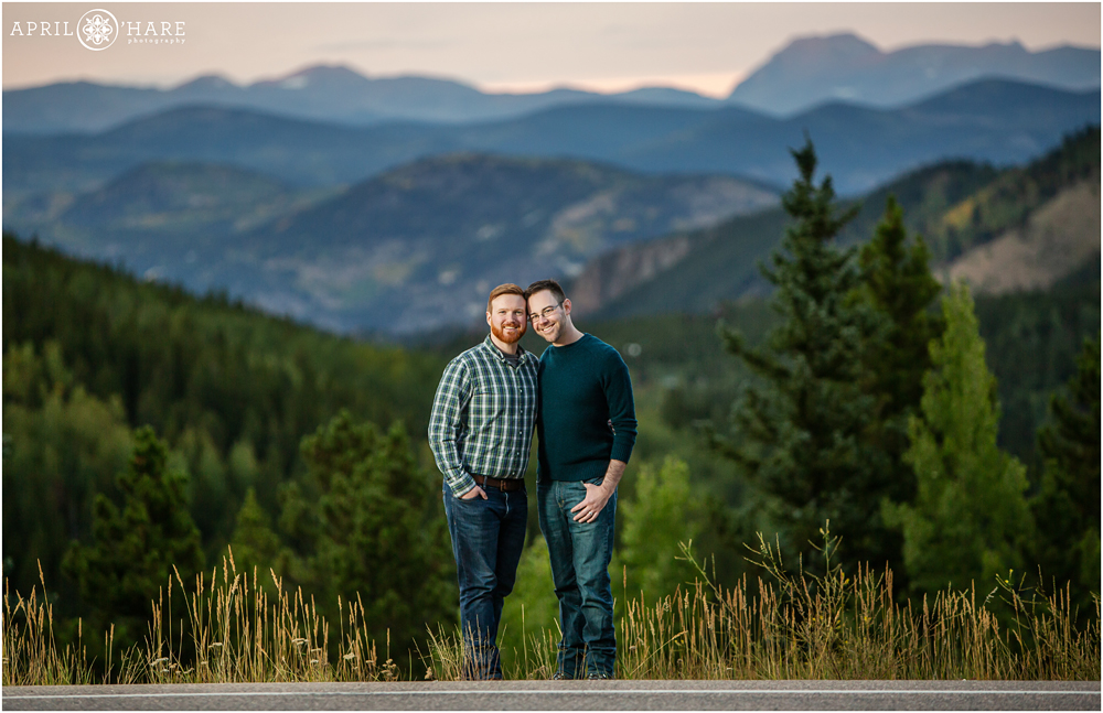 Colorado gay engagement photo with gorgeous blue mountain backdrop in Evergreen