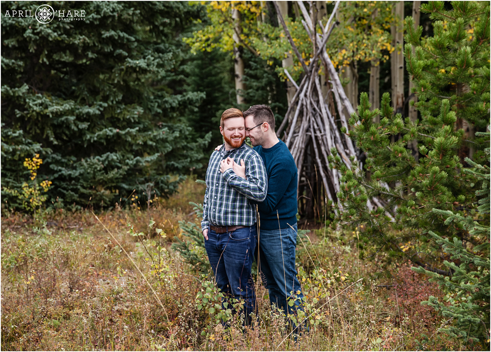 Romantic cuddle engagement photo during fall in the mountains of Colorado