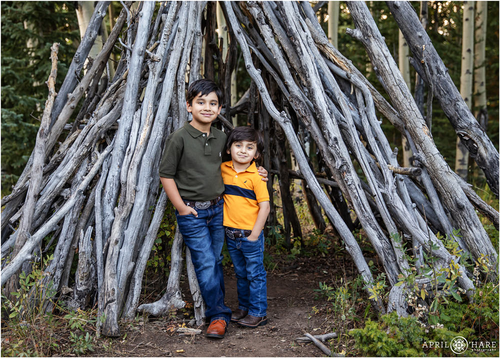 Sweet Brother Photo with wood tipi in a Colorado mountain forest in Evergreen