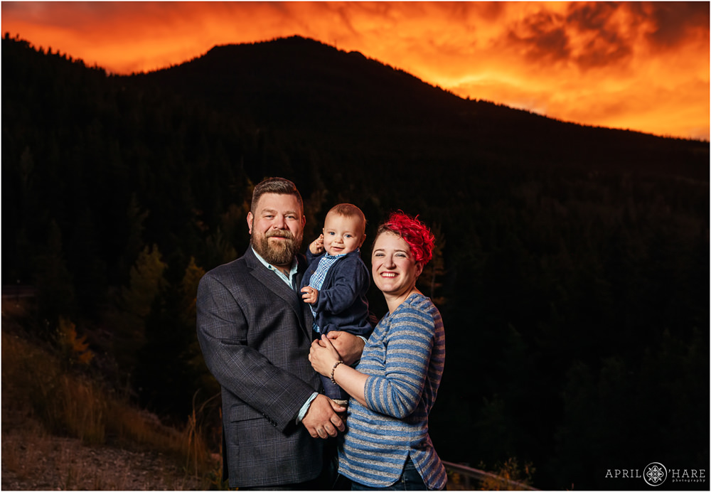 Gorgeous fiery sunset sky in the mountains for a family photography session in Colorado
