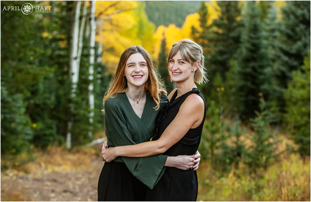 A sweet photo of a senior girl and her mom with a pretty fall color backdrop in Evergreen Colorado