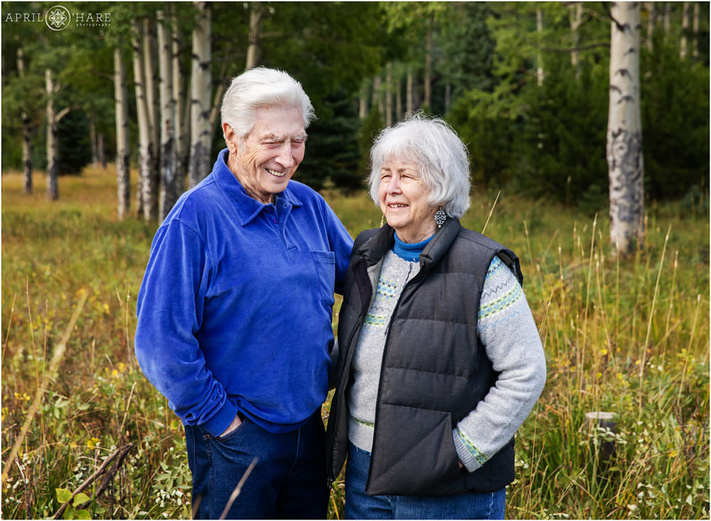 Older parents laugh during their family photography session on Squaw Pass Road in Evergreen Colorado
