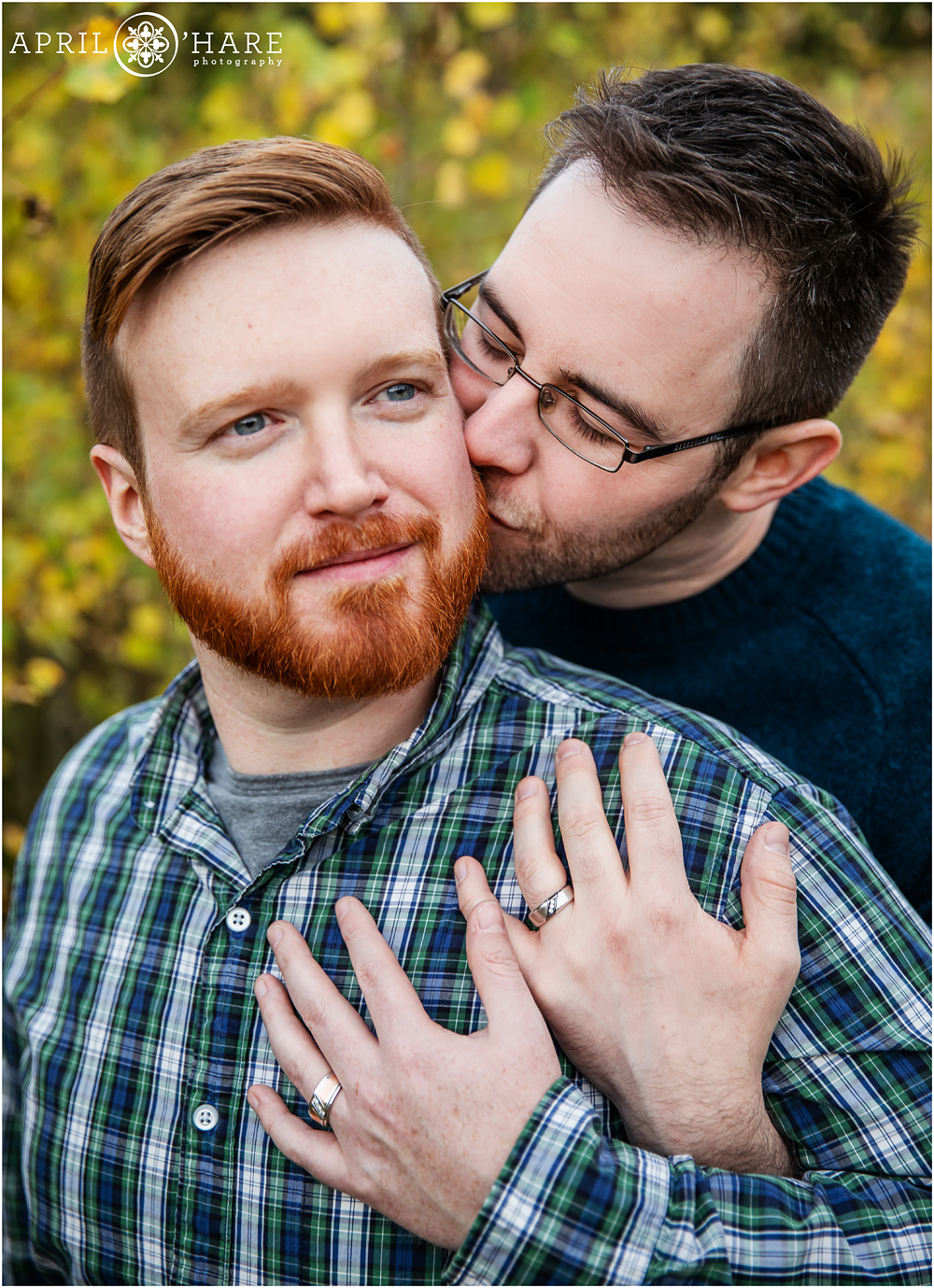 Two guys show off their engagement rings at their fall color Colorado engagement photo session