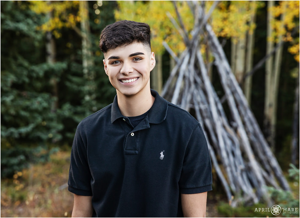 Denver Senior Yearbook Photography with wood tipi backdrop during fall in the mountains