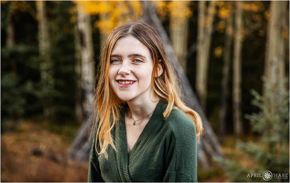 Pretty colorful high school senior portrait in an aspen tree forest on Squaw Pass Road in Colorado