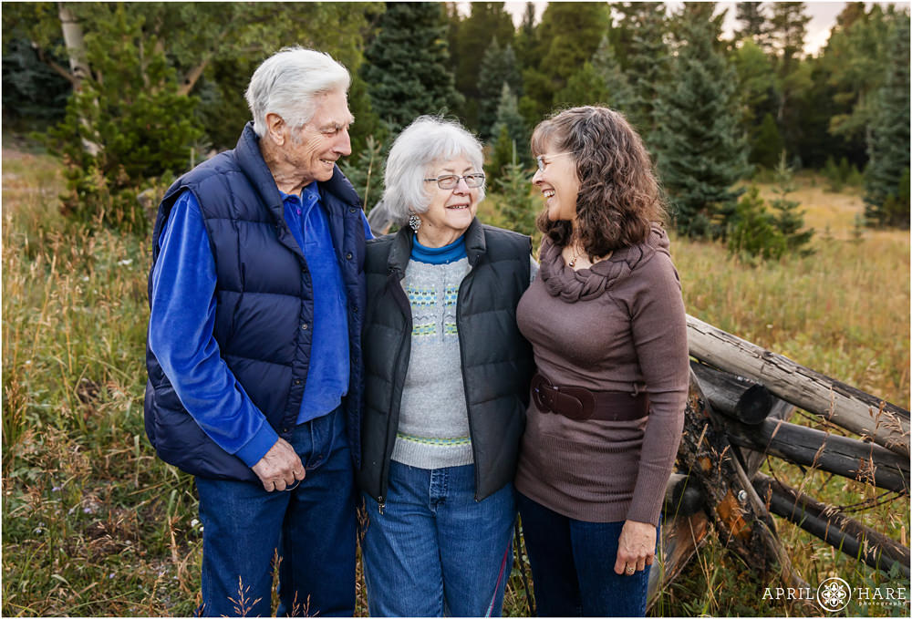 Family laughing together during their family photography session on Squaw Pass Road in Evergreen Colorado