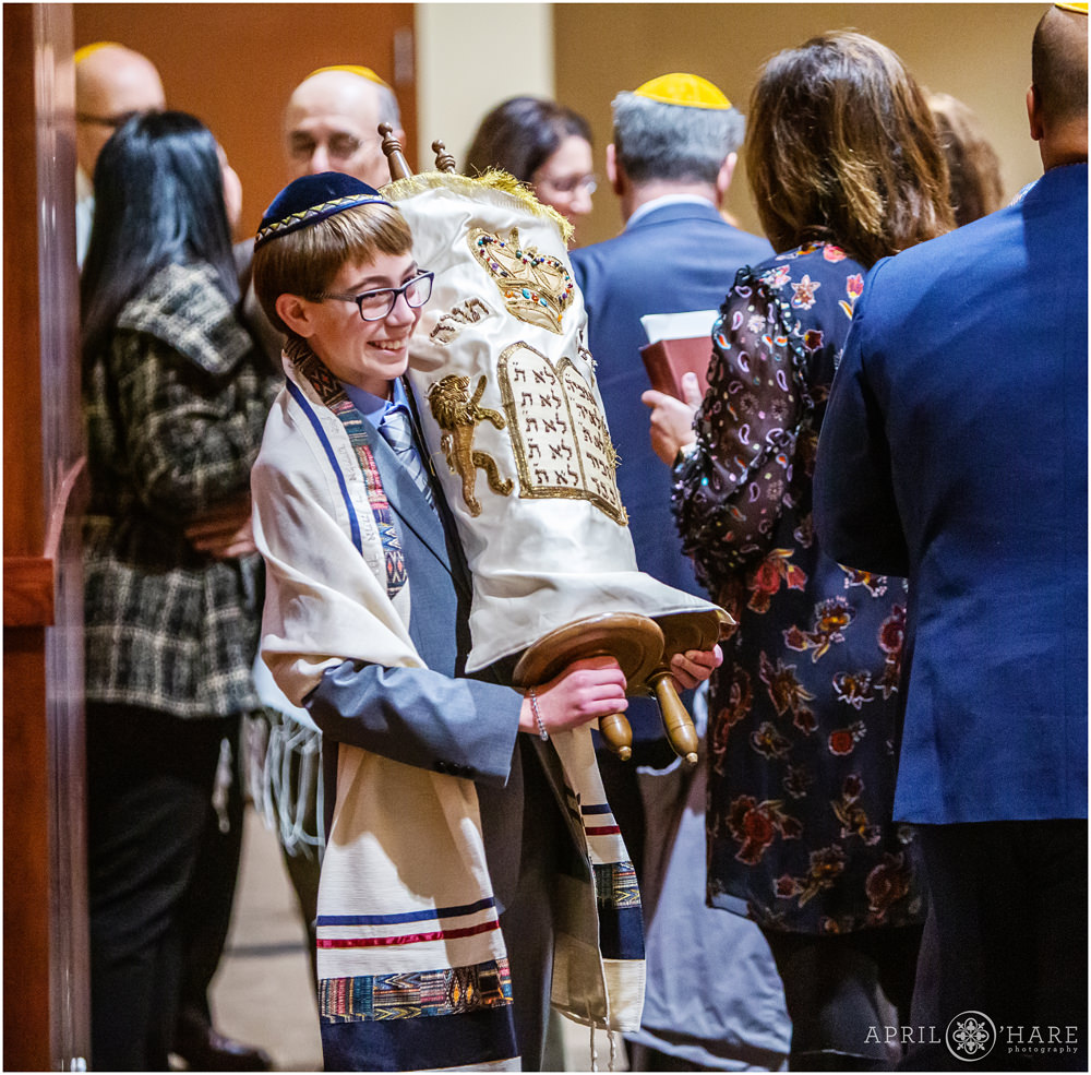 Bar Mitzvah boy carries the torah around the room during his bar mitzvah service at the Lincoln Center in Fort Collins Colorado