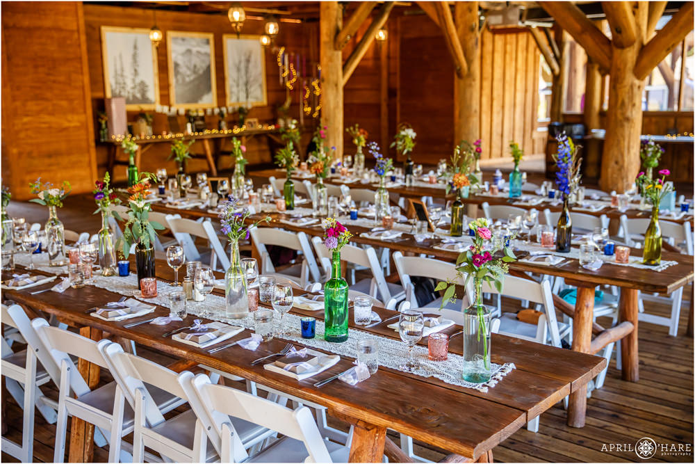 Rustic Vail Wedding Reception decor with wildflowers and lace table runners at Piney River Ranch