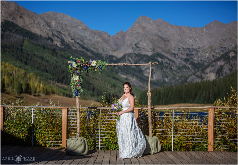 Full length portrait of bride in front of a pretty mountain view at Piney River Ranch