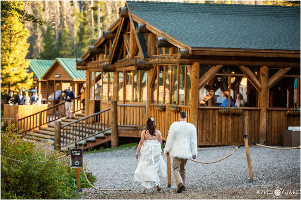 Candid wedding photo of bride and groom walking back to their reception in Vail Colorado