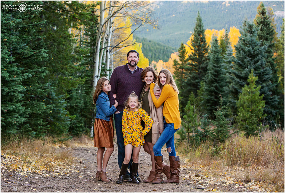 Beautiful posed portrait of a family wearing gold during autumn on Squaw Pass Road in Colorado
