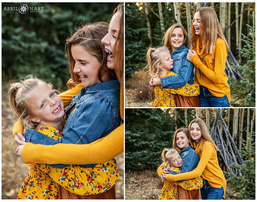 Pretty fall color Colorado candid family photography with 3 sisters hugging each other in the woods of Evergreen