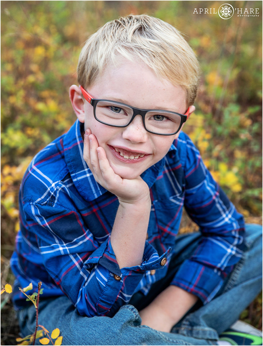 Cute individual photo of a young boy at his blended family photography session during fall at Fox Run Park