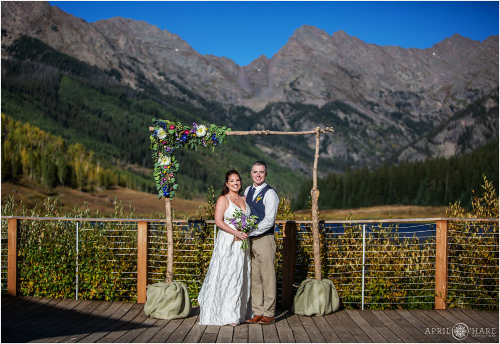 Classic Colorado Wedding Photo with gorgeous mountain backdrop on a bright and sunny day