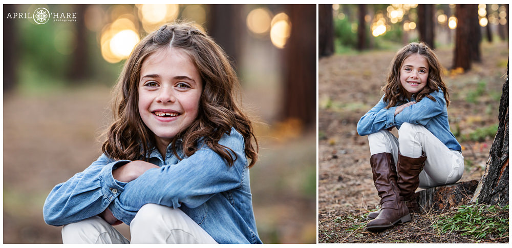 A cute girl wearing white jeans with button up blue jean shirt poses for individual portrait at her family session Colorado Springs