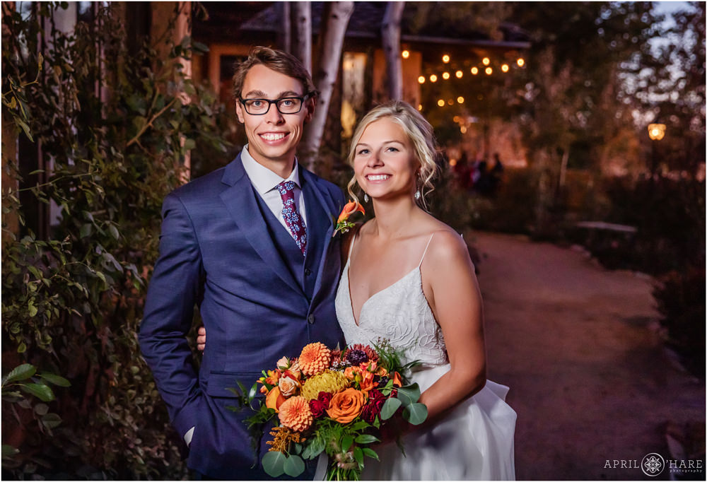 Beautiful wedding portrait at dusk with orange florals from fall wedding day at Villa Parker
