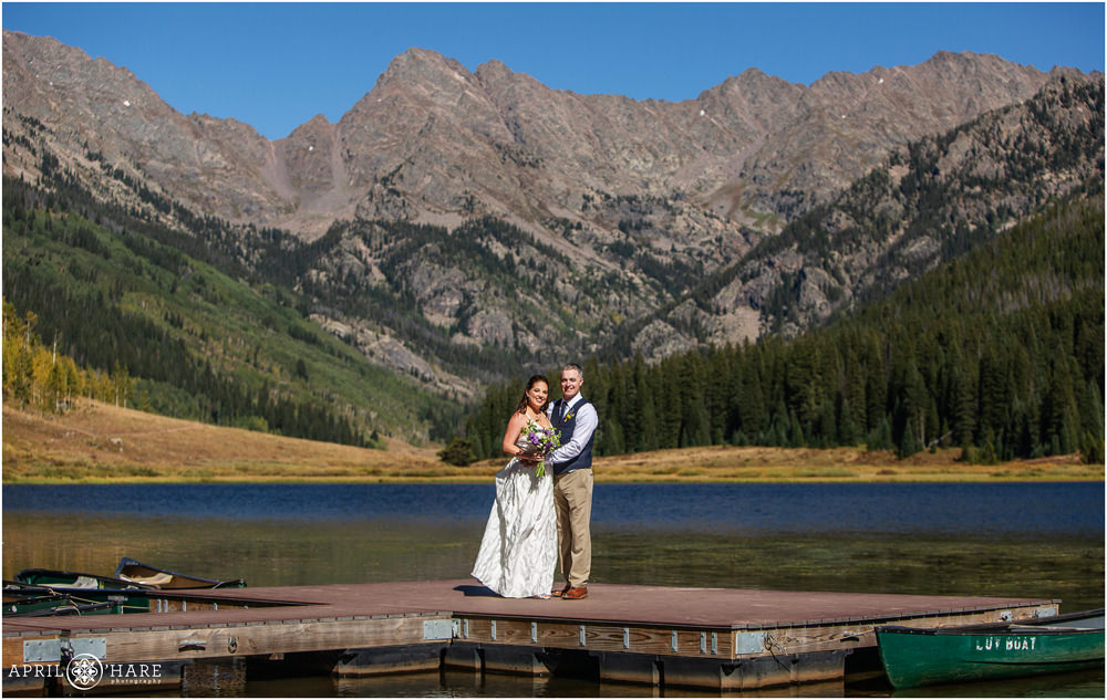 Beautiful colorful Colorado mountain wedding photo on a dock at Piney Lake