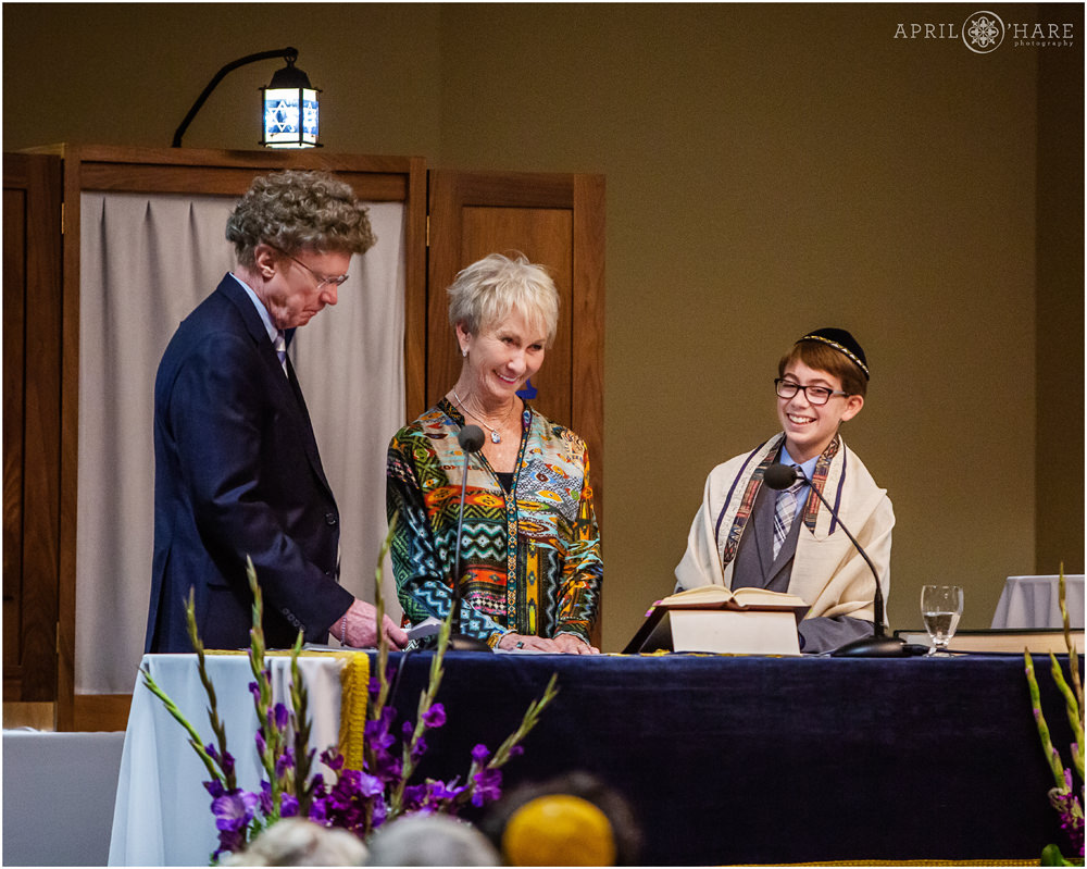 A bar mitzvah boy with his grandparents during his service at the Lincoln Center in Fort Collins