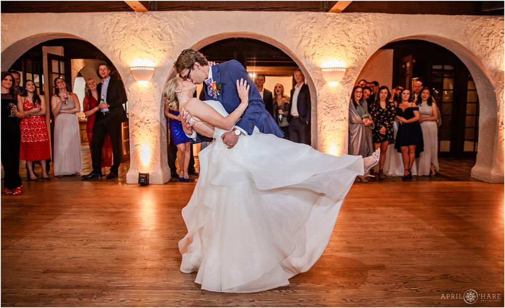 Groom dips his bride for a romantic first dance wedding photo at Villa Parker in Colorado