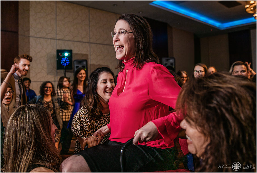 Mom of a bar mitzvah boy is lifted into the air at a party at the Lincoln Center in Colorado