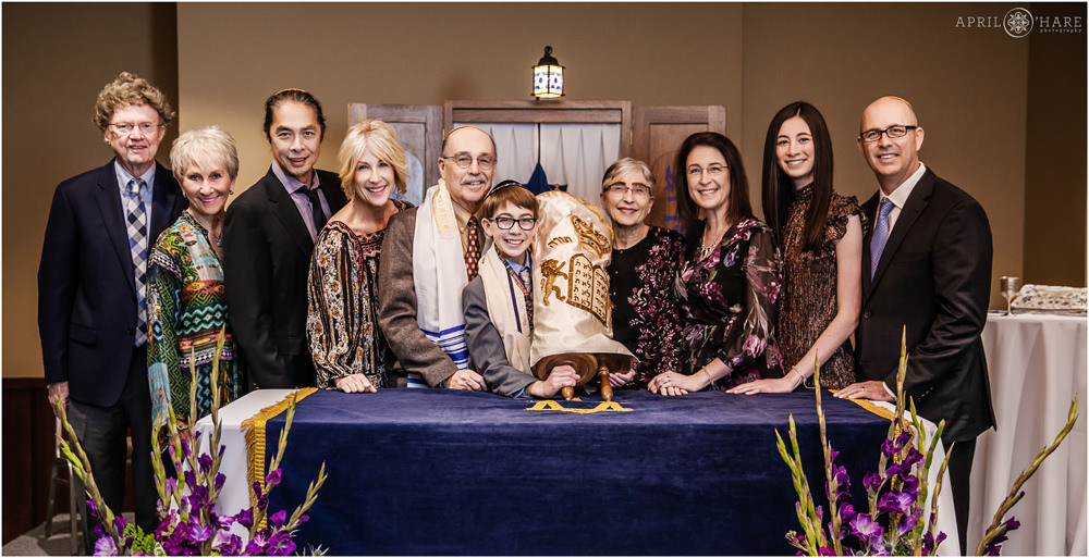 A Family portrait with the Torah at a bar mitzvah at the Lincoln Center in Fort Collins