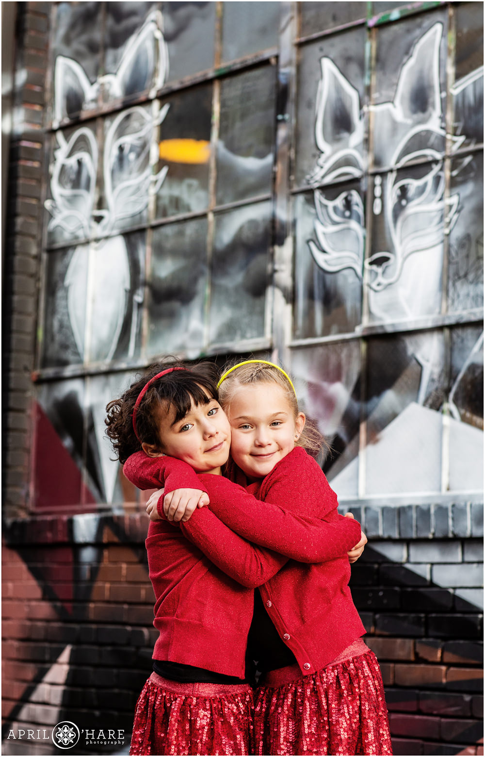 Adorable sister picture with cute foxes street art in alley behind Central Market in Rino area of Denver Colorado