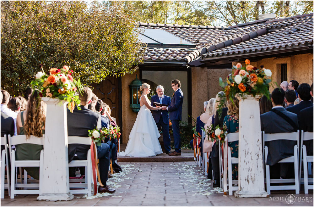Bride and groom outdoor wedding ceremony courtyard of Villa Parker in Colorado