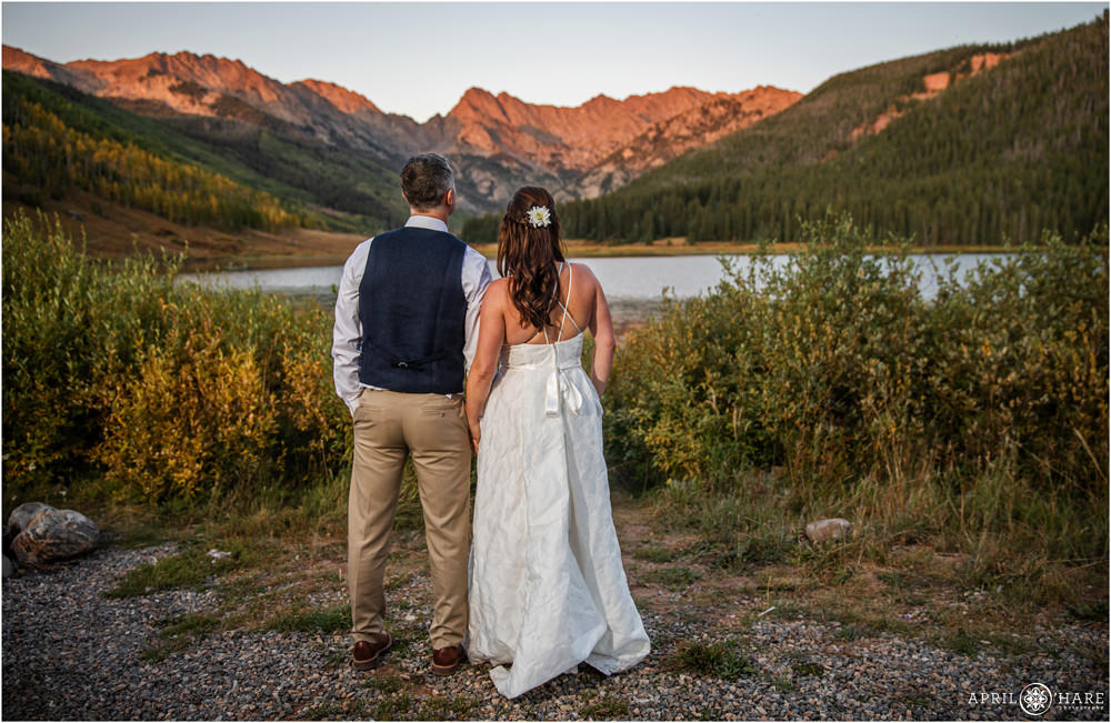 Bride and groom look out at the view at Piney River Ranch in Vail Colorado