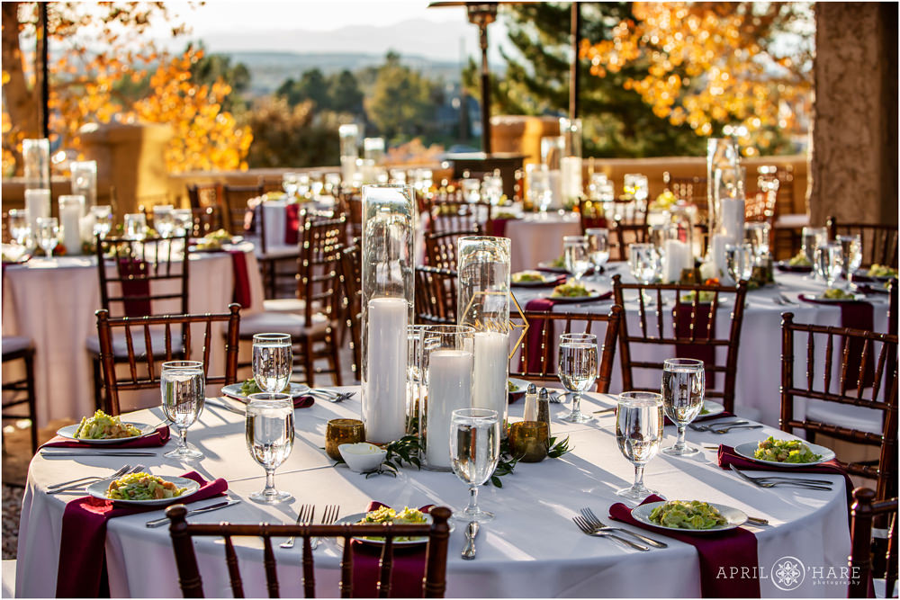 Tables set up for wedding dinner at Villa Parker in Colorado with mountains off in the distance during fall