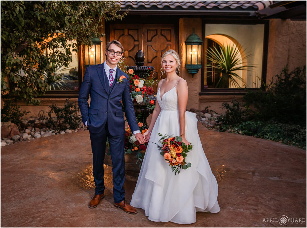 Bride and groom portrait in front of the fountain in the courtyard of Villa Parker at Dusk