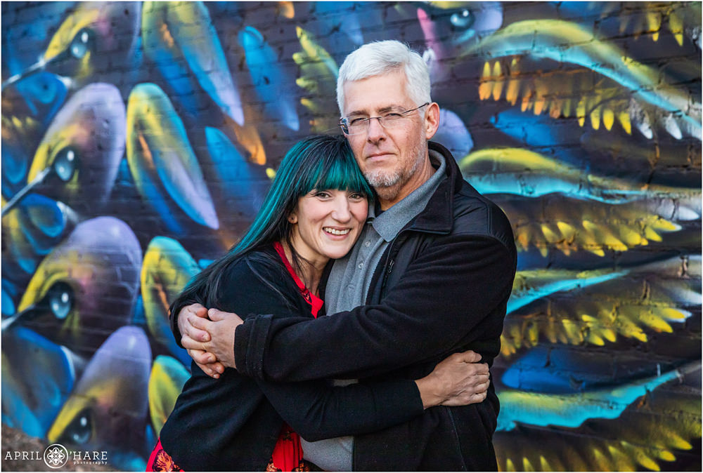 Mom and Dad alone family photo with hummingbird street art wall mural backdrop in Rino