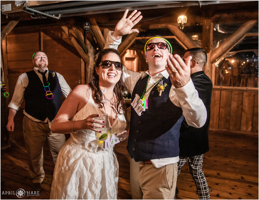 Bride and groom with glowsticks dance at their wedding reception in Vail Colorado
