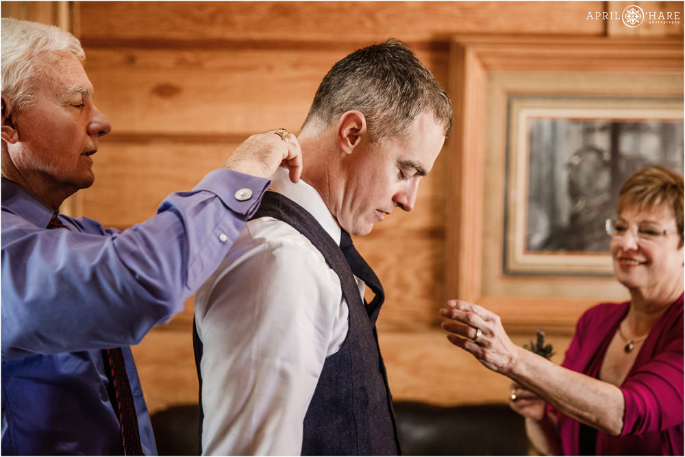 Groom's parents fuss over him on his wedding day at Piney River Ranch in Vail