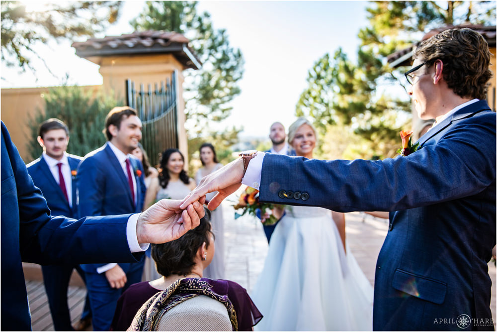 Groom shows off his ring before formal portraits in Colorado at Villa Parker Wedding