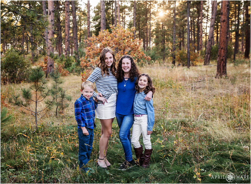 Sibling photo during a blended family photography session during fall color season at Fox Run Park