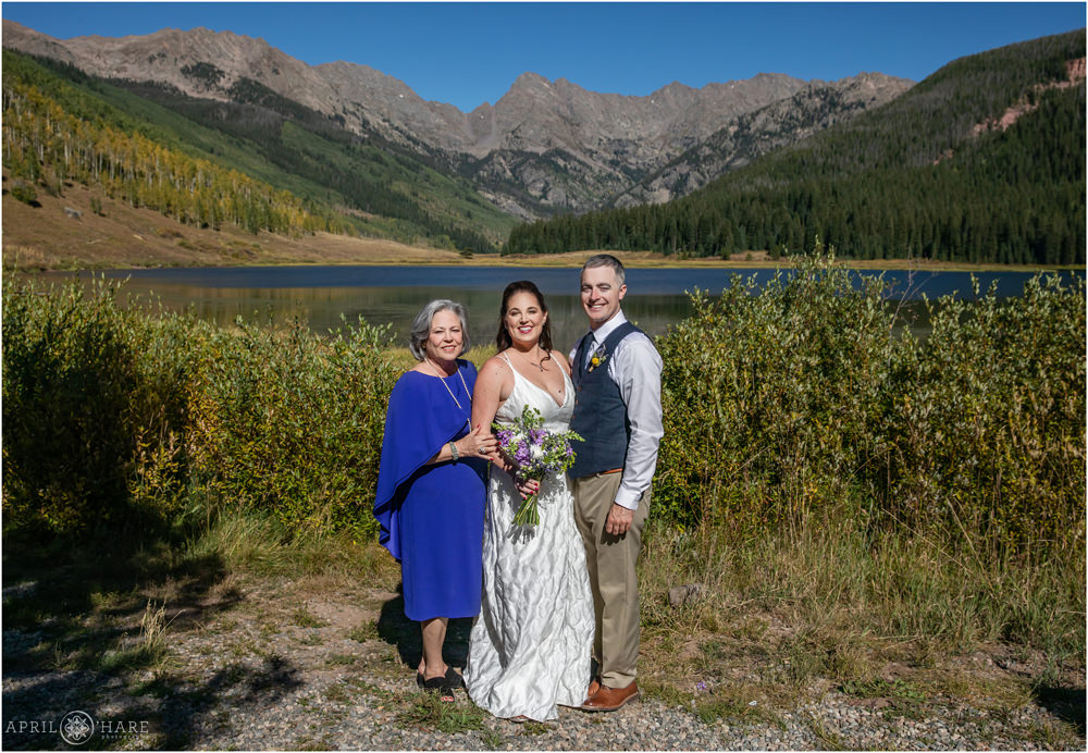 A Family photo with gorgeous mountain views on a bright sunny wedding day in Colorado