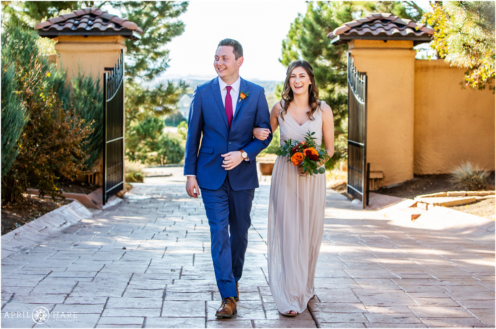Best man and maid of honor walk down the aisle at Villa Parker wedding during fall in Colorado