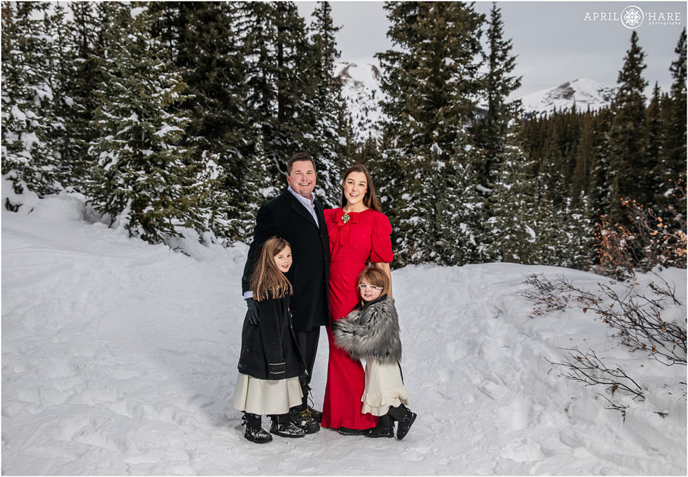 A pretty Colorado Christmas winter family portrait in the snow at Mayflower Gulch Trailhead near Leadville