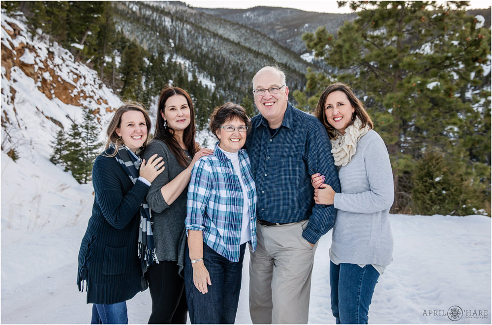 Parents with their three grown daughters at Colorado snowy family photo session in Evergreen