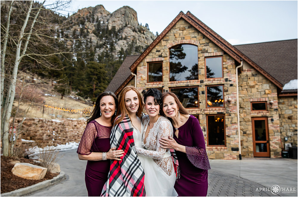 Beautiful family portrait with two brides and their moms outside of Della Terra on a cold winter day in December