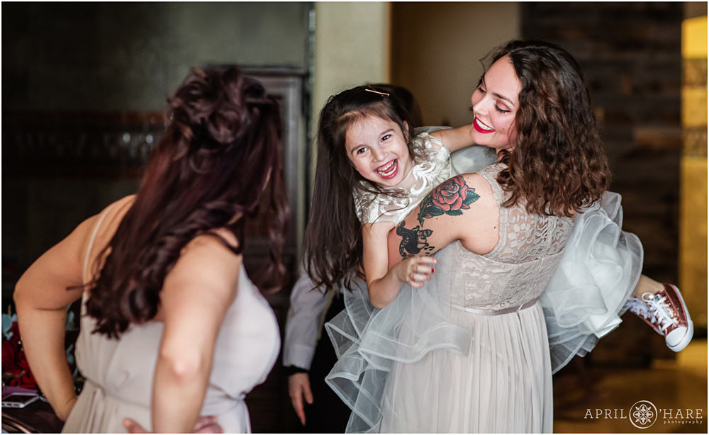 Aunt swings her niece around for a candid photo in the Della Terra Bridal Suite