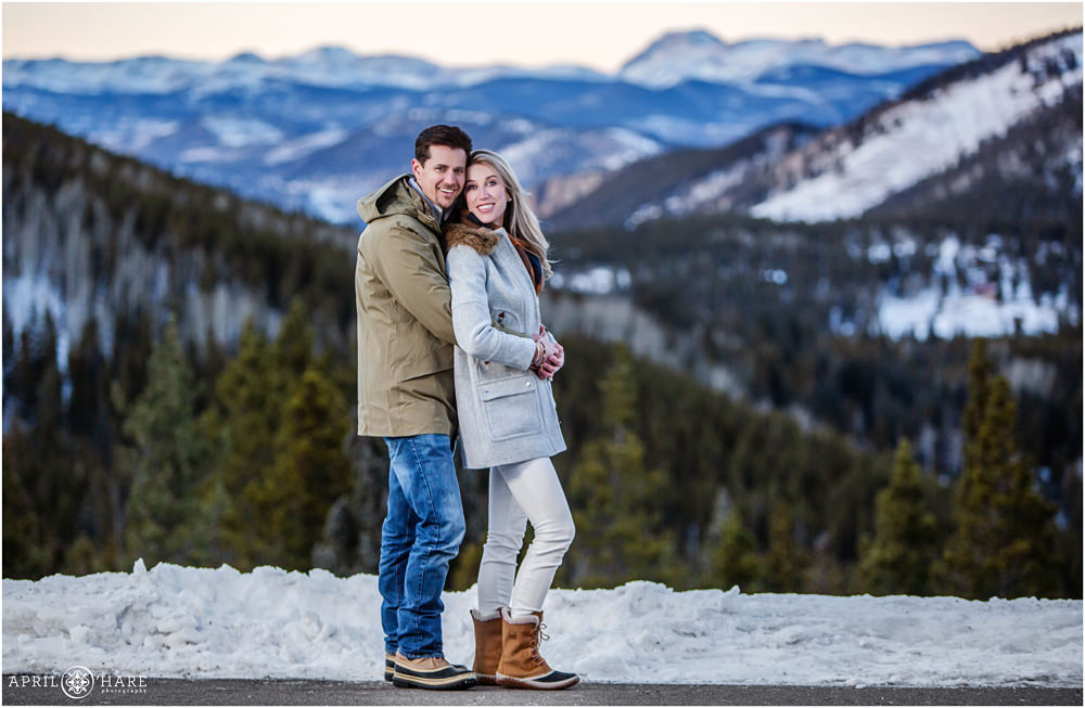 Stunning couples portrait at family photography session with pretty snowy Colorado mountain backdrop in Evergreen