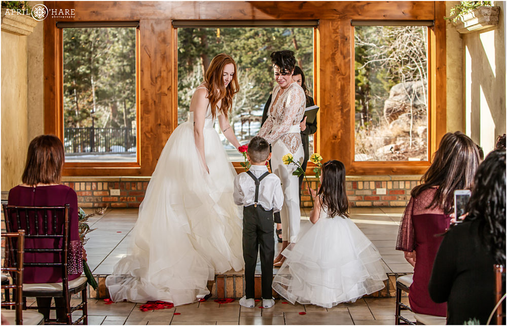 Indoor wedding ceremony with two lesbian brides at Della Terra Mountain Chateau