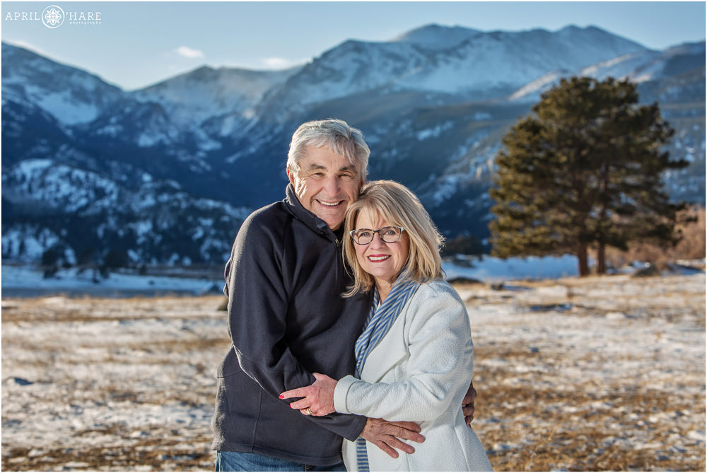 Grandparent family photo with pretty blue mountain backdrop at Rocky Mountain National Park