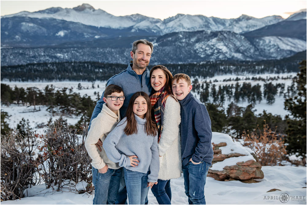 Stunning sunset family pictures with snowy mountain backdrop in Estes Park CO