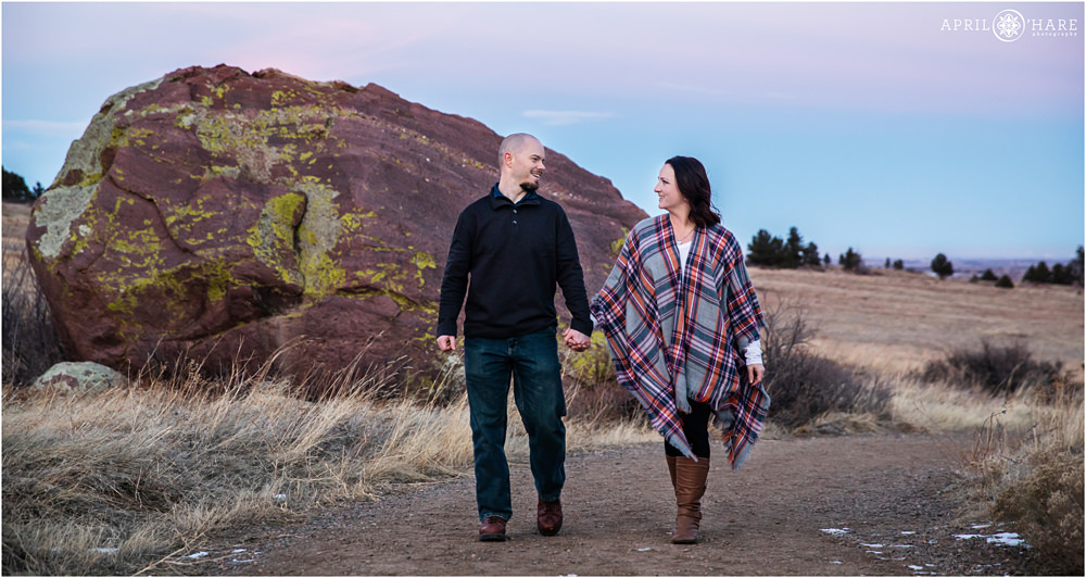 Couple hold hands at their Boulder Photography Session at South Mesa Trail in Boulder during winter