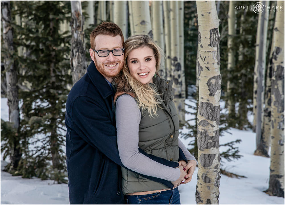 Engaged couple pose for a forest portrait in Colorado