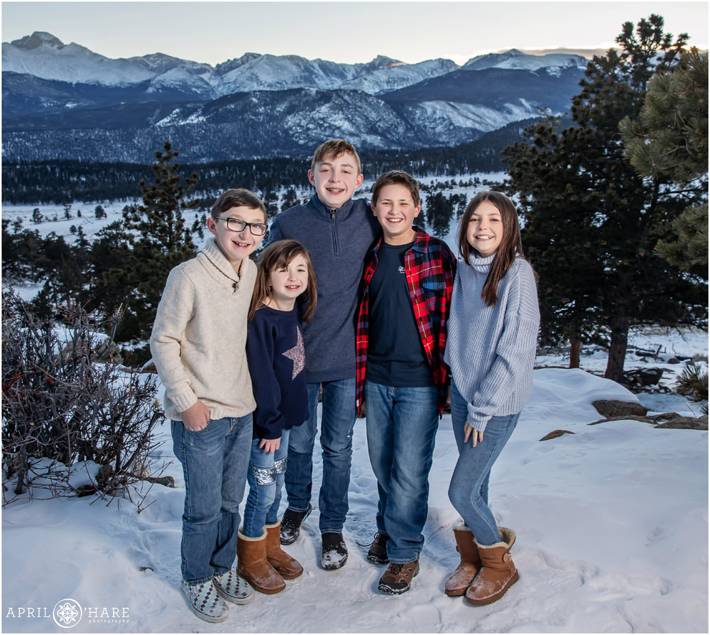 Cousins pose for a cute photo in the snow at RMNP in Estes Park