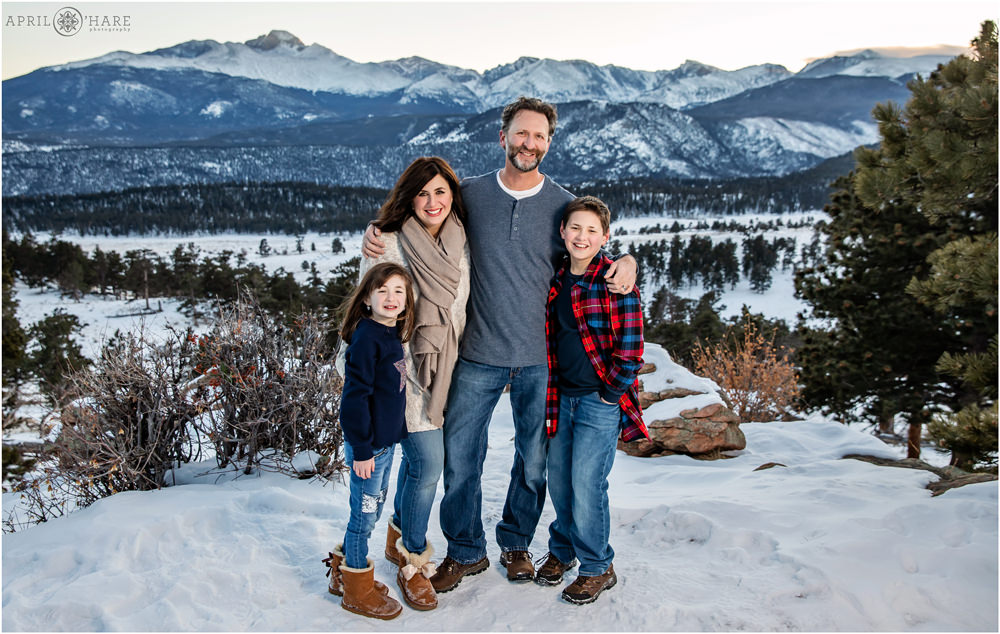 Family of four picture with pretty snowy mountain backdrop at RMNP